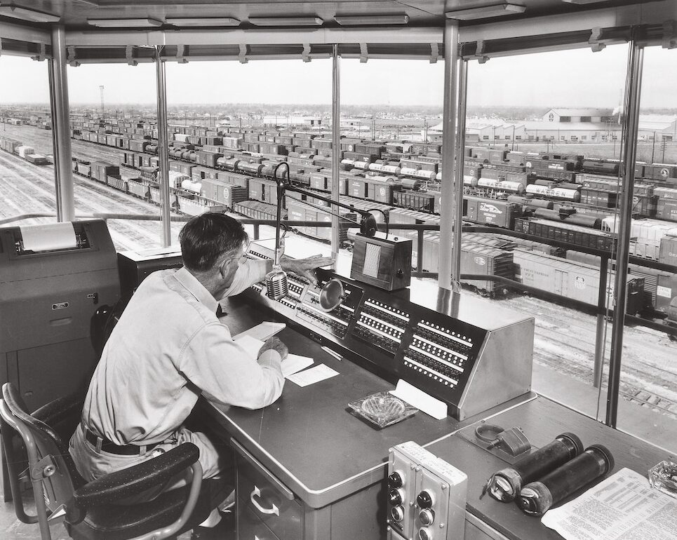 Man in a rail yard tower oversees yard operations