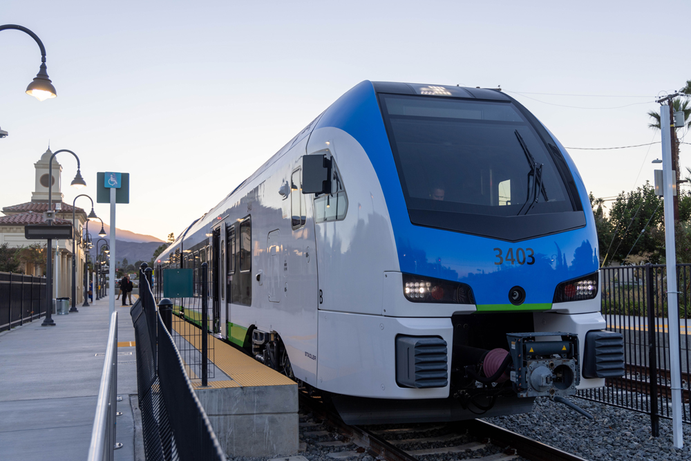 Blue and white DMU train at station