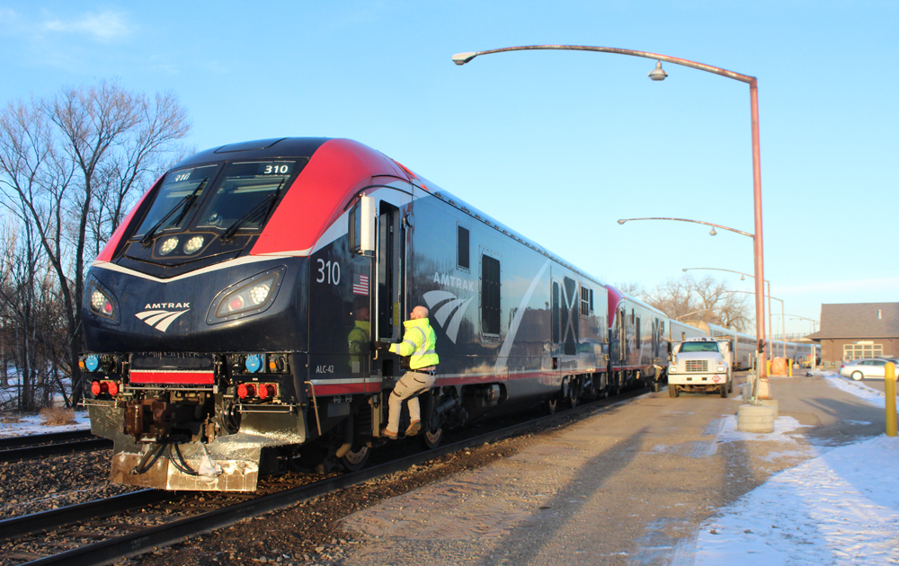 Blue and red locomotives on passenger train