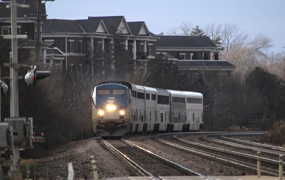 Train rounds curve in suburban area