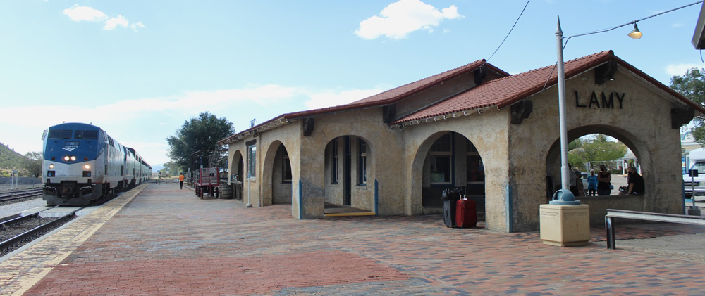 Train arrives at Spanish-style station