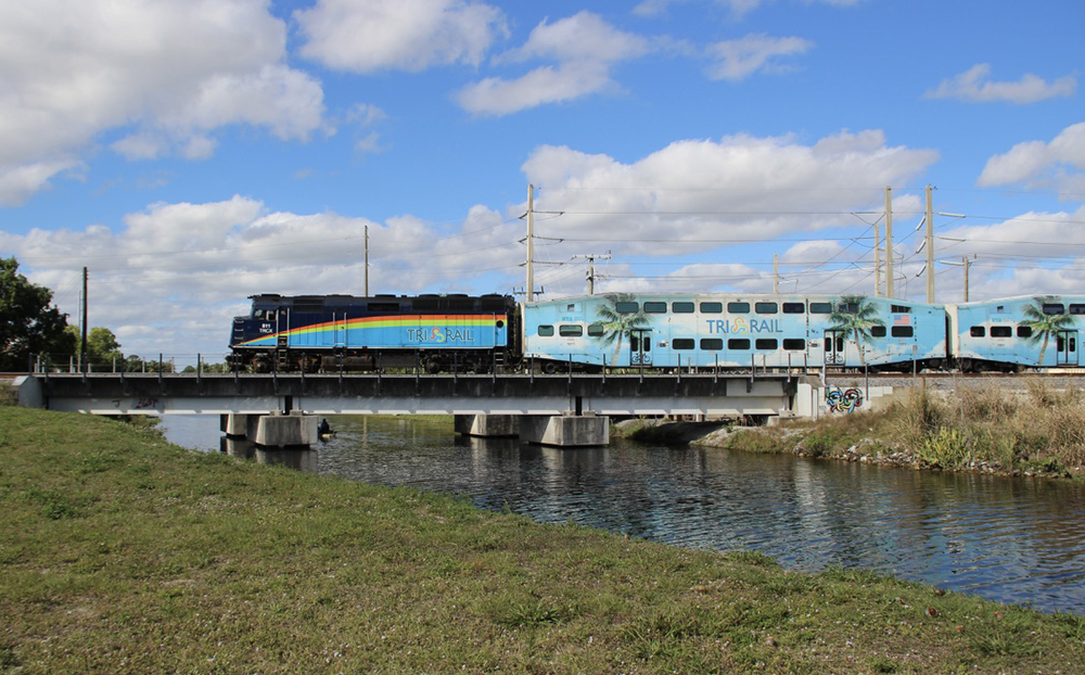 Commuter train crossing low bridge