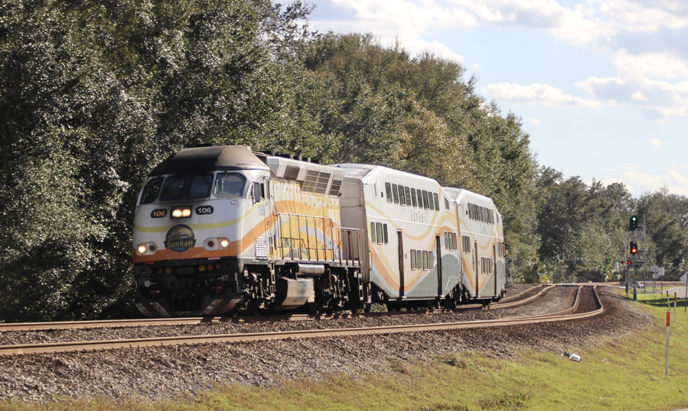 Locomotive with two bilevel passenger cars rounding curve