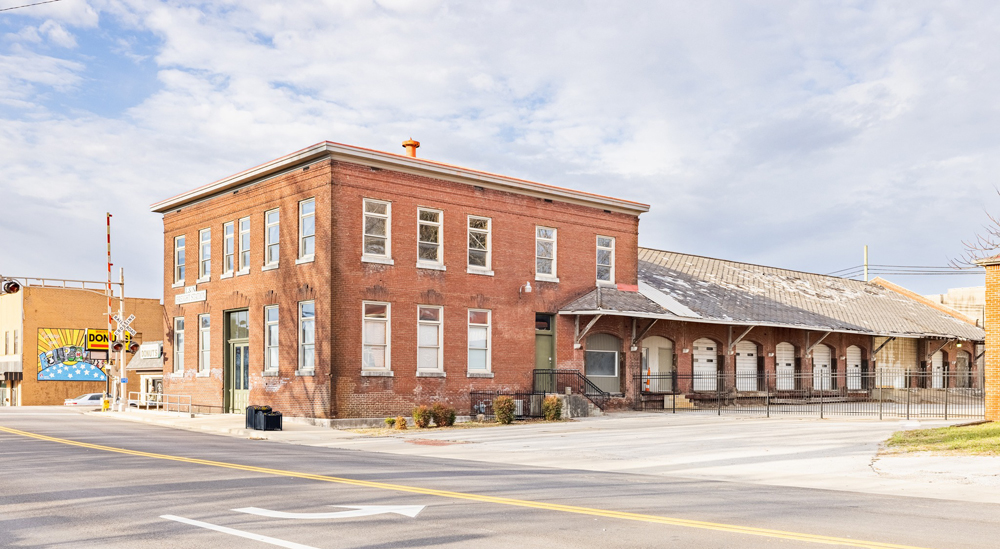 Three-quarters view of two-story brick building