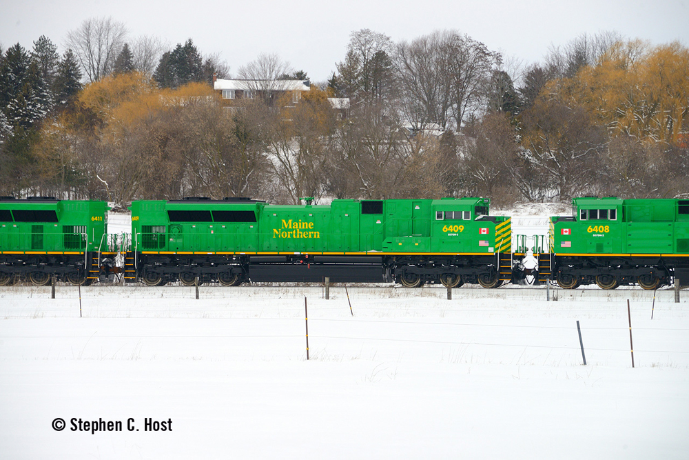 Bright green locomotive with yellow 'Maine Northern' lettering