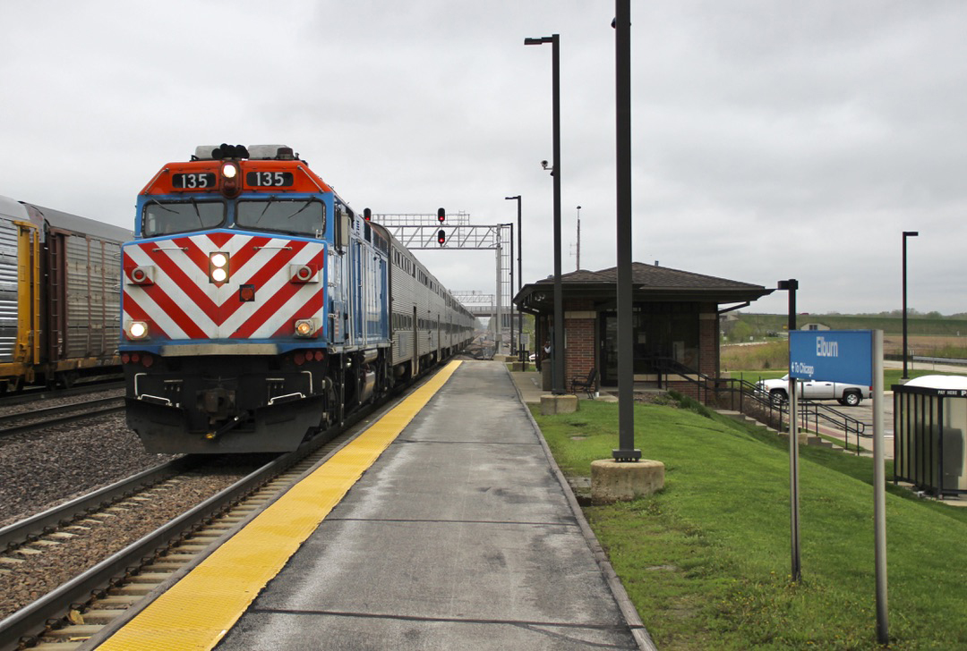 Commuter train arrives at station on cloudy day