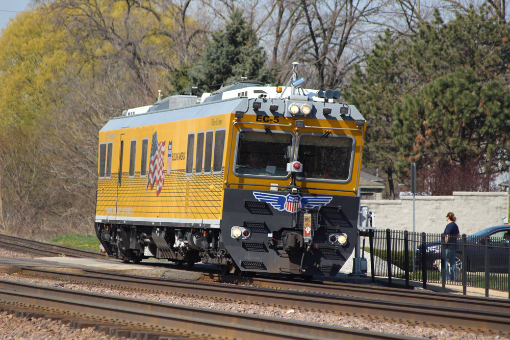 Yellow self-propelled track inspection car