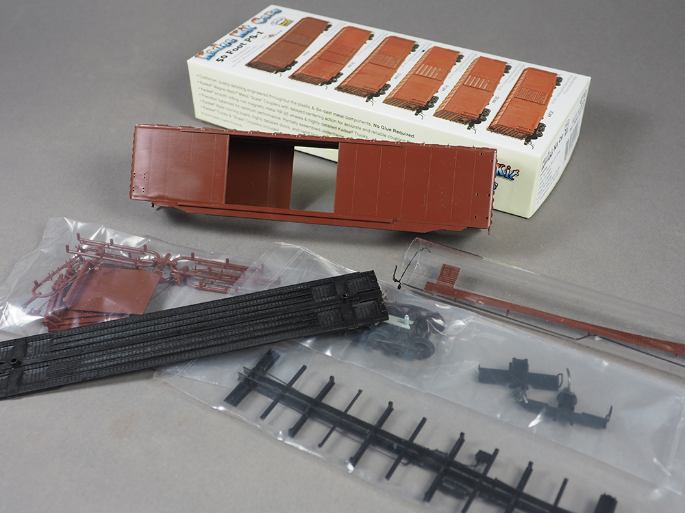 Car Swap Project Part 3: Painting plastic models - Brown plastic boxcar kit with small parts in clear bags