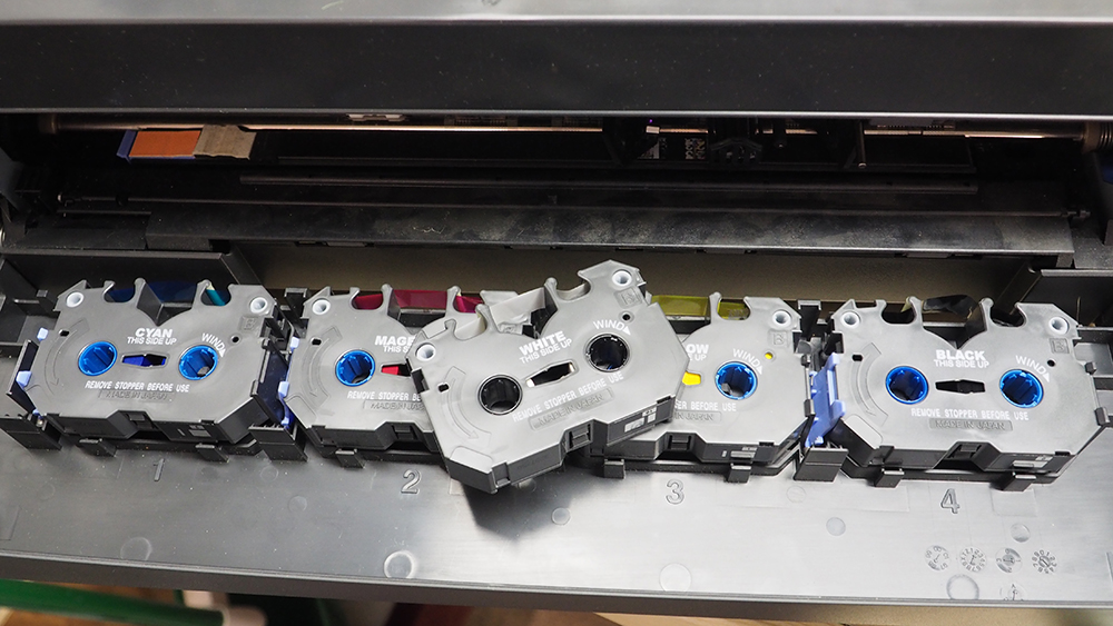 Car Swap project part 5: Printing decals with an ALPS printer: Five small, gray ink cassettes inside black printer case