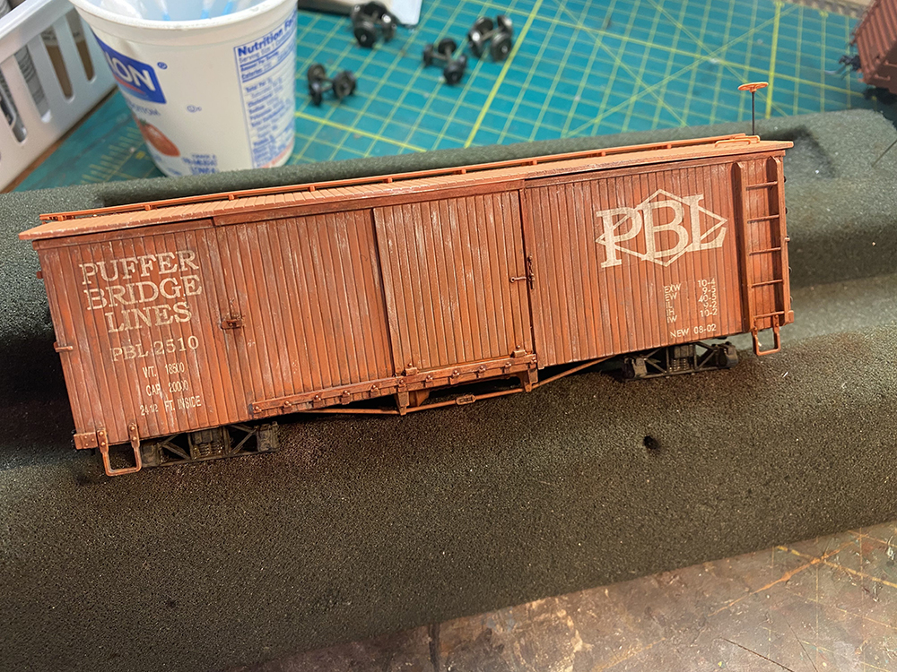 Car Swap Project part 6: Seth’s techniques for decals and weathering: Brown model boxcar on workbench with faded paint