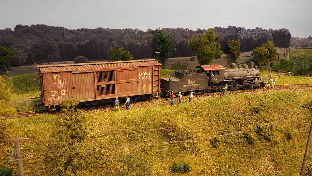 Car Swap Project part 9: Lessons learned: Oversized brown model boxcar behind black steam locomotive on finished model railroad