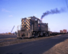 Olive green Louisville & Nashville diesel locomotive in yard