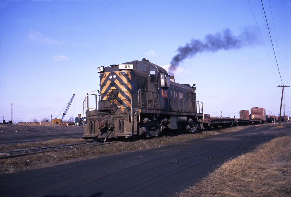 Olive green Louisville & Nashville diesel locomotive in yard