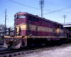 Red-and-yellow Louisville & Nashville diesel locomotive in yard
