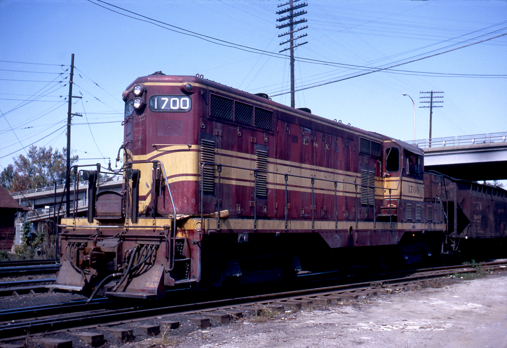 Red-and-yellow Louisville & Nashville diesel locomotive in yard