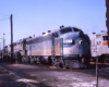 Blue-and-gray Louisville & Nashville diesel locomotive in freight yard
