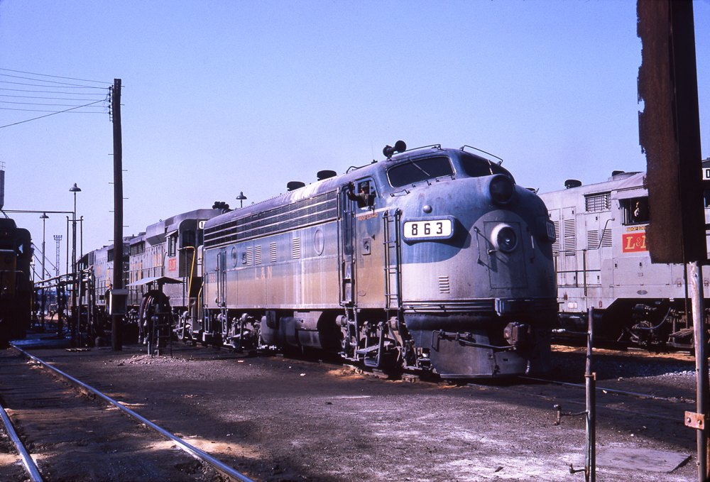 Blue-and-gray Louisville & Nashville diesel locomotive in freight yard