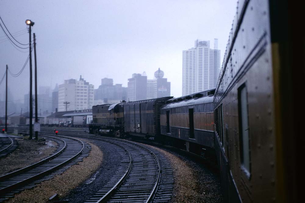 Black-and-gold passenger train on curve from Monon Railroad history