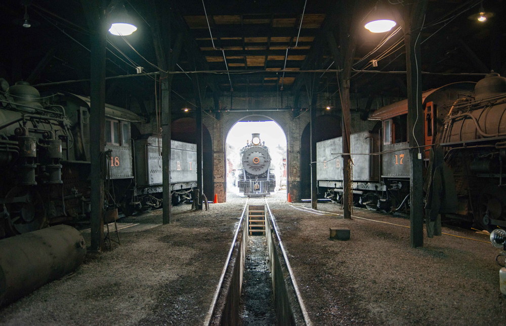 View from inside roundhouse of locomotive sitting outside