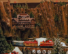 A train in front of a lodge in a canyon
