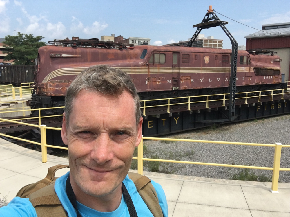 man next to a GG1 locomotive