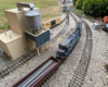 model locomotive on curve near recycling plant