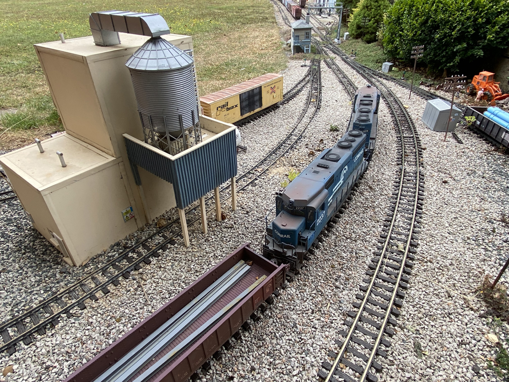 model locomotive on curve near recycling plant