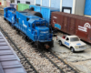 two blue model switch engines on a garden railroad
