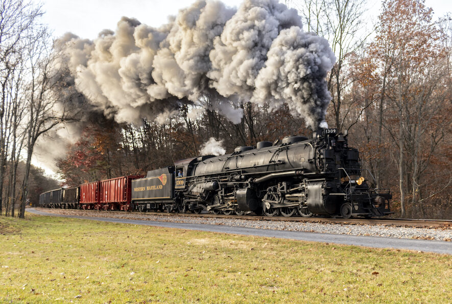 With heavy smoke pouring from its stack, Western Maryland No. 1309 powers a freight train in Fall 2022