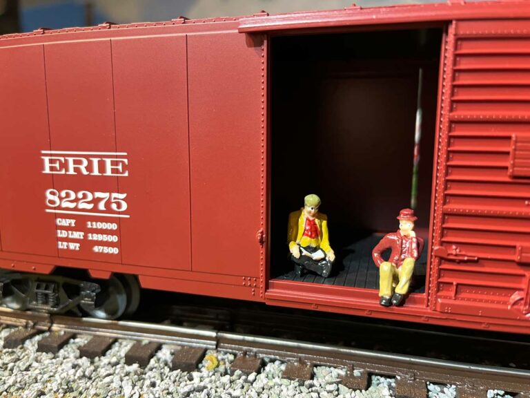 the lionel hobo car figures sitting in door