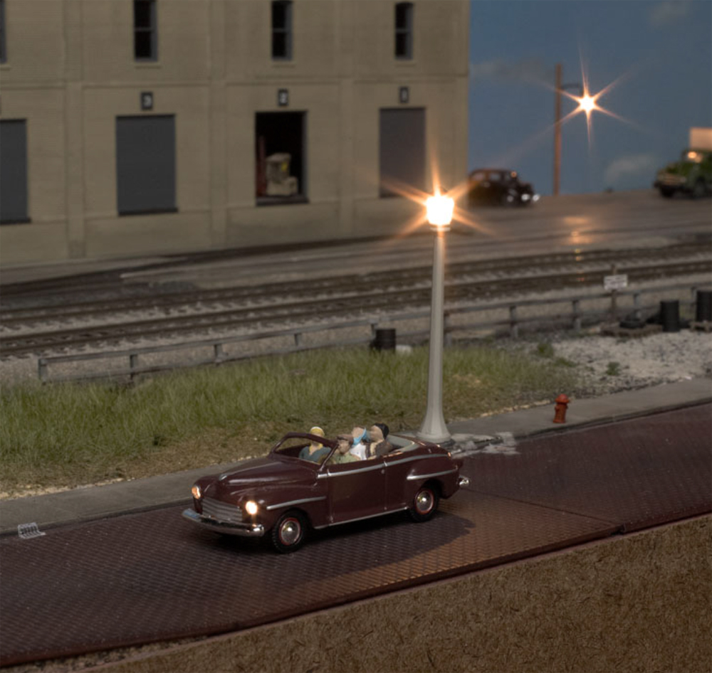 An image of a model convertible on a model railroad layout