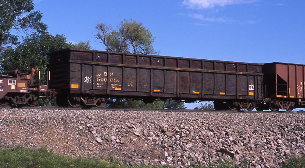 Color photo of gondola painted black with side extensions.