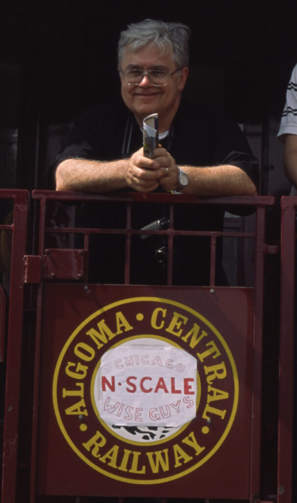 Charles Vlk, career model railroader, dies at 78: Photo of a man on an observation car platform