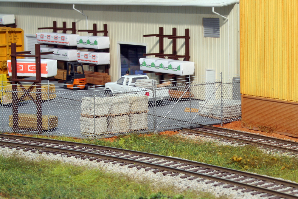 Photo of gate section of chain link fence on model railroad.