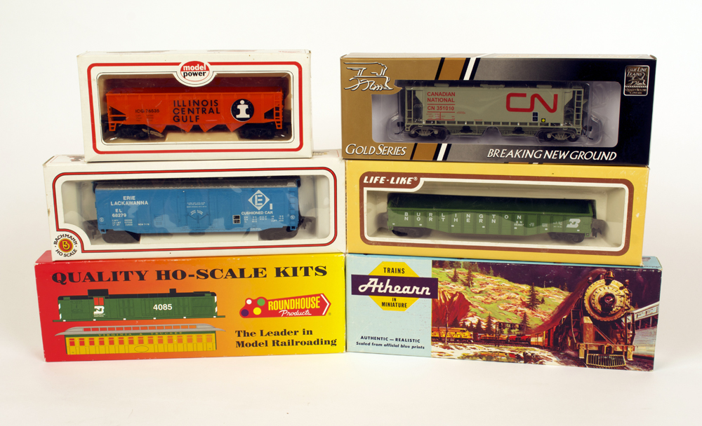 Photo of six HO scale freight cars on white background