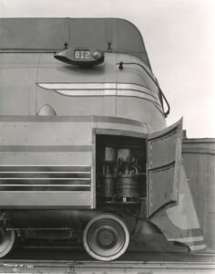 Front side of a Milwaukee Road streamlined steam locomotive with an open door to access equipment.