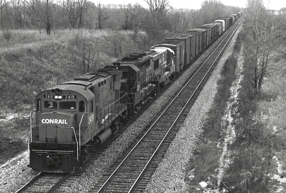 A Conrail freight train pulled by locomotives from Alco, EMD, and GE.