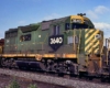 green-and-yellow diesel locomotive on freight train
