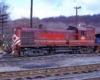Red-and-yellow diesel locomotive with blue caboose