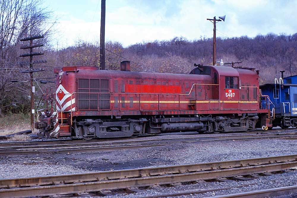 Red-and-yellow diesel locomotive with blue caboose