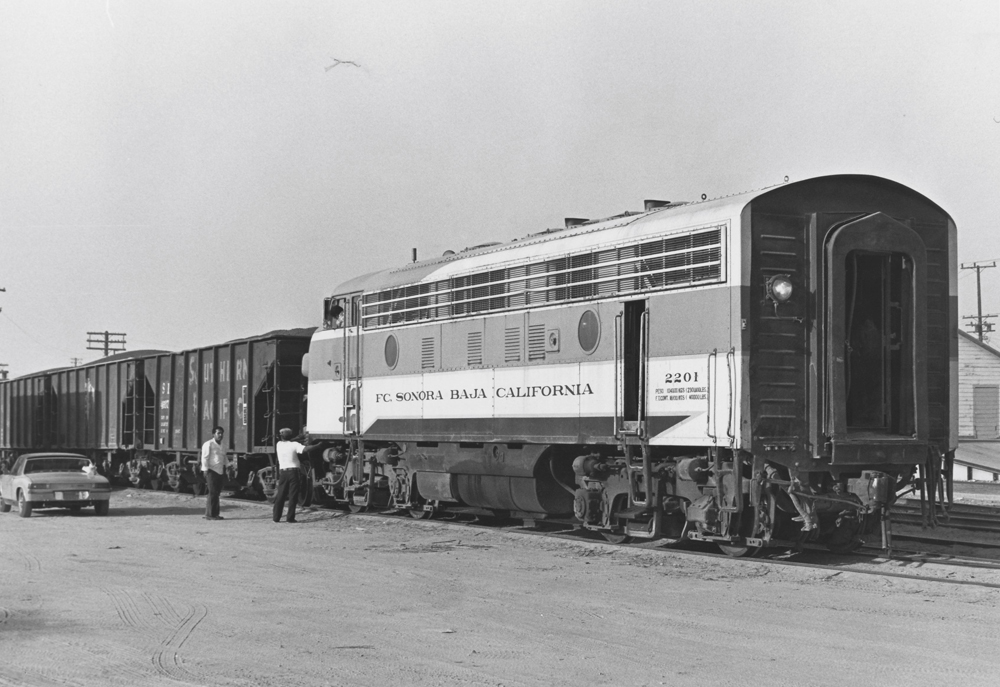 black and white photo of train with crew