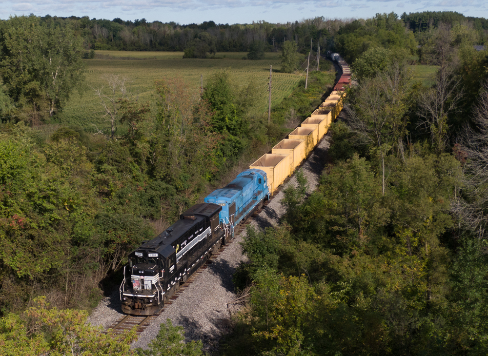 black and blue locomotives hauling freight