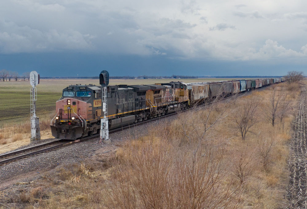 dark, multi-colored train with overcast sky