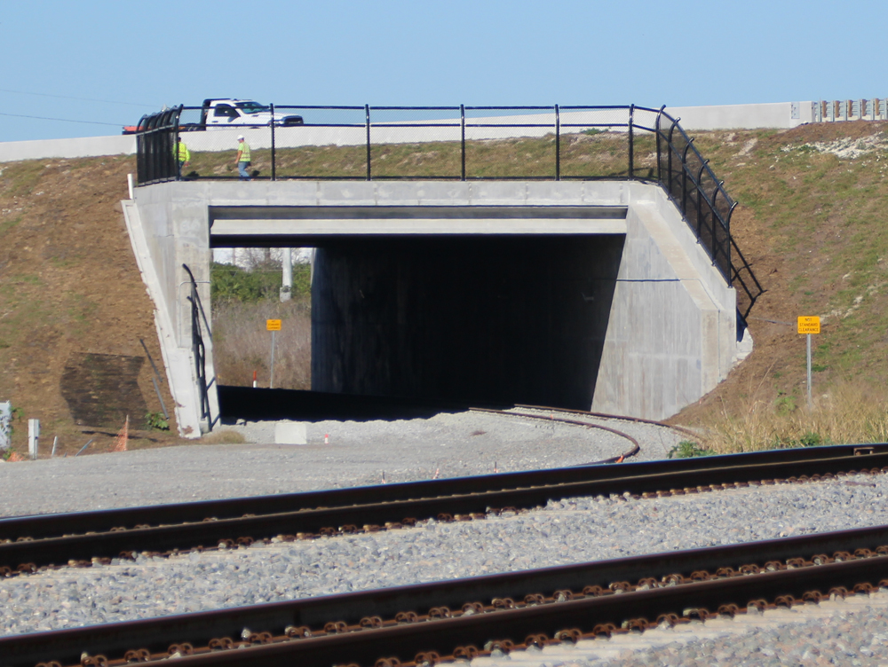 Two men above rail underpass