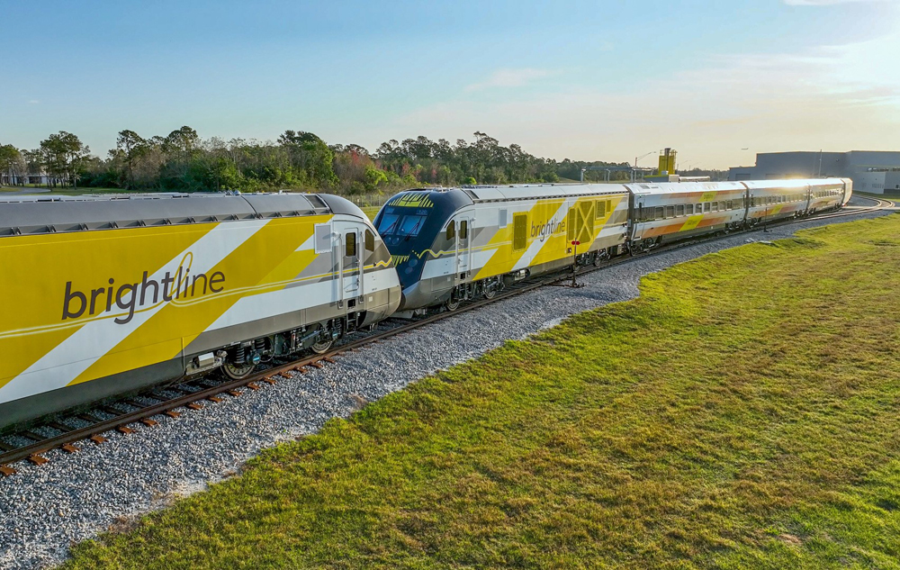 Two locomotives and passenger trainset arrive at maintenance facility