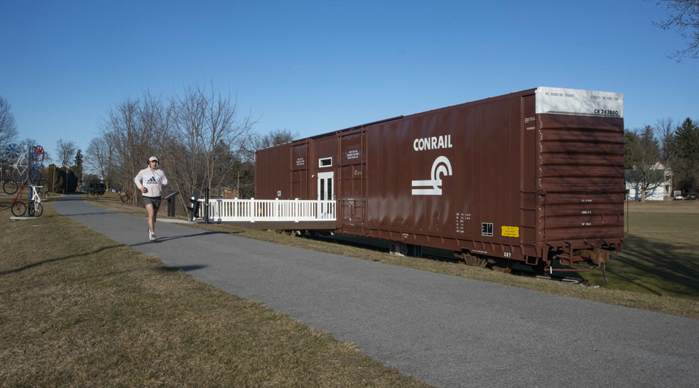 86-foot boxcar on section of track next to trail