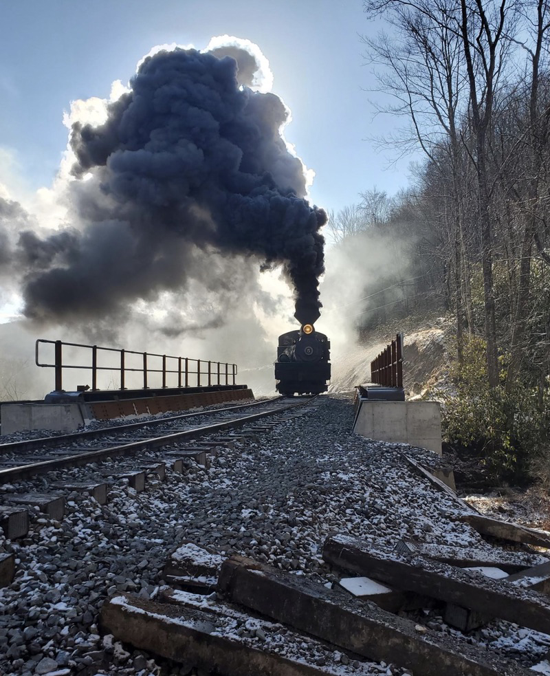 Steam locomotive prepares to cross bridge
