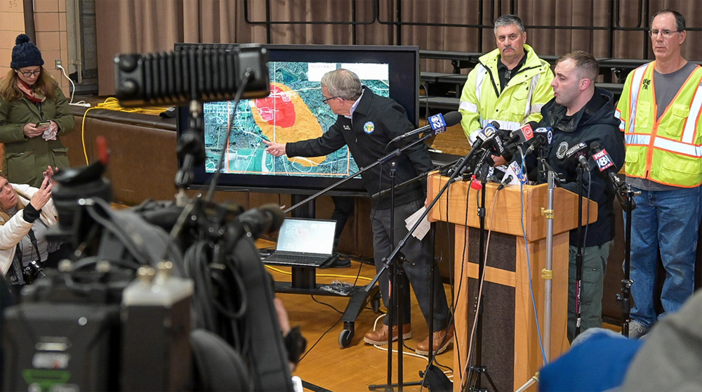 Man gestures at video screen