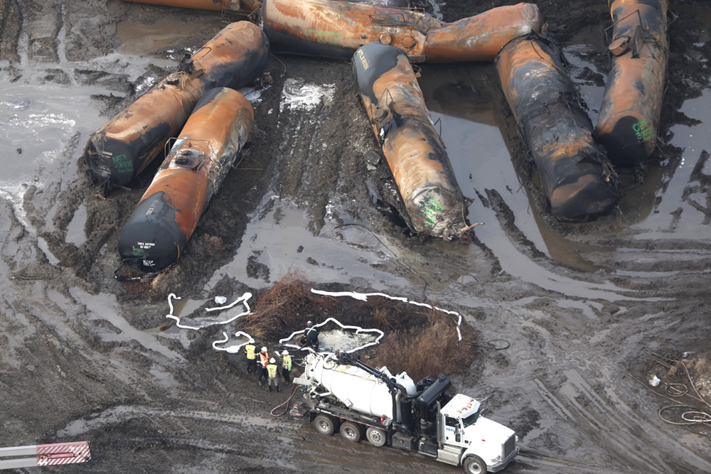 Burned out tank cars and tank truck in muddy area