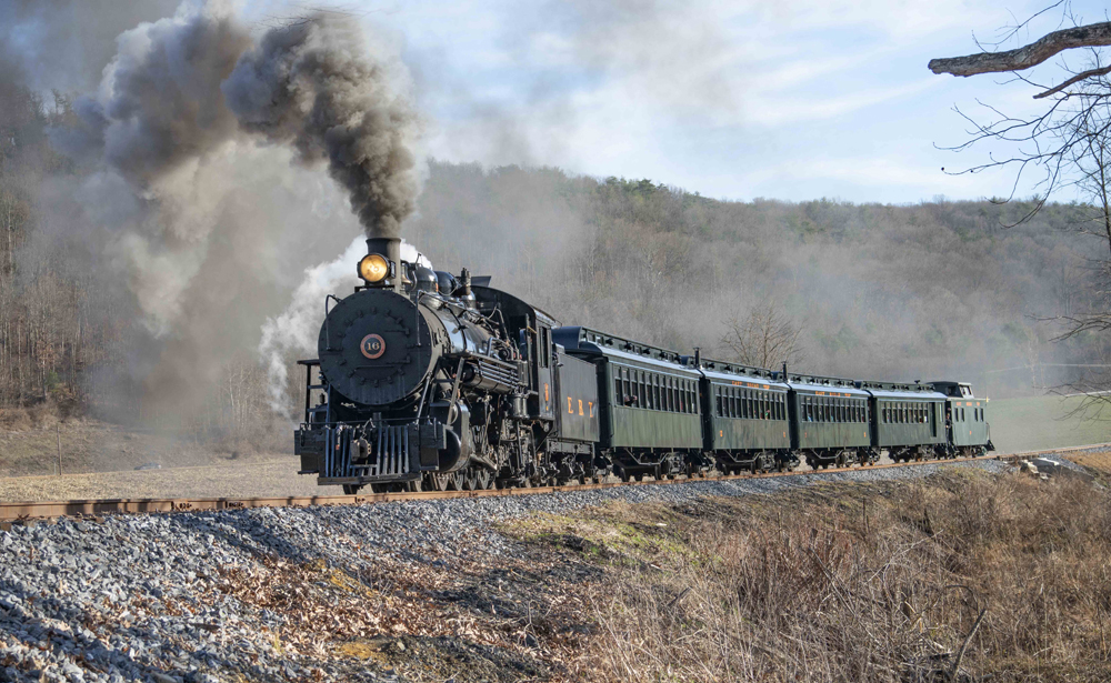 Steam locomotive with four passenger cars and caboose